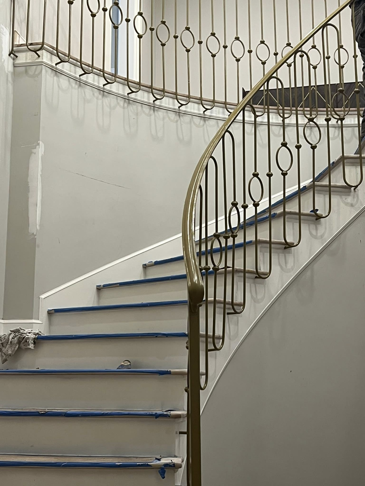 Curved staircase with ornamental iron railing