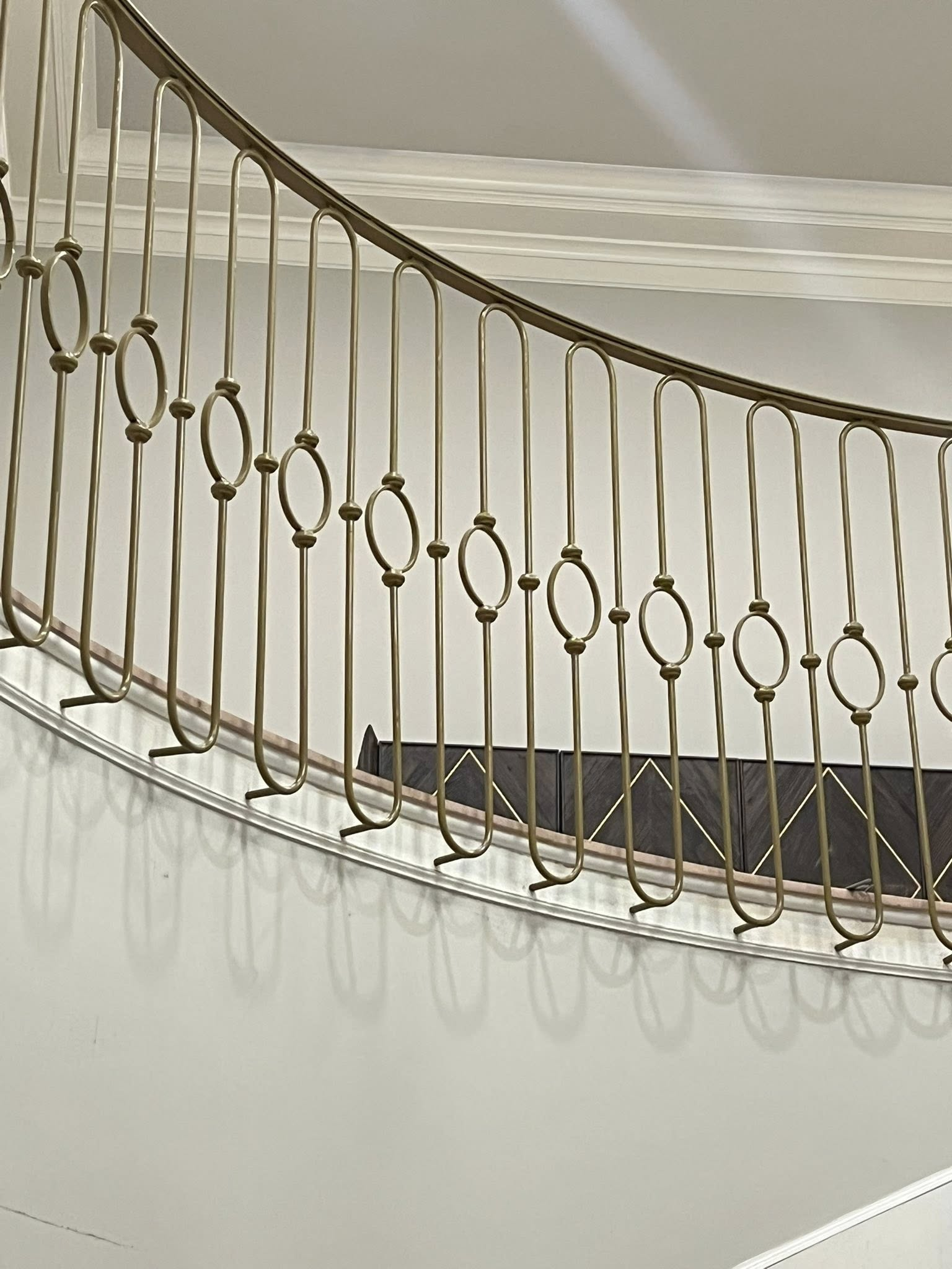 Custom ornamental balcony railing with gold finish